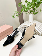 MIUMIU 26S SLINGBACK PUMPS 55MM IN BLACK SUEDE WITH BOW