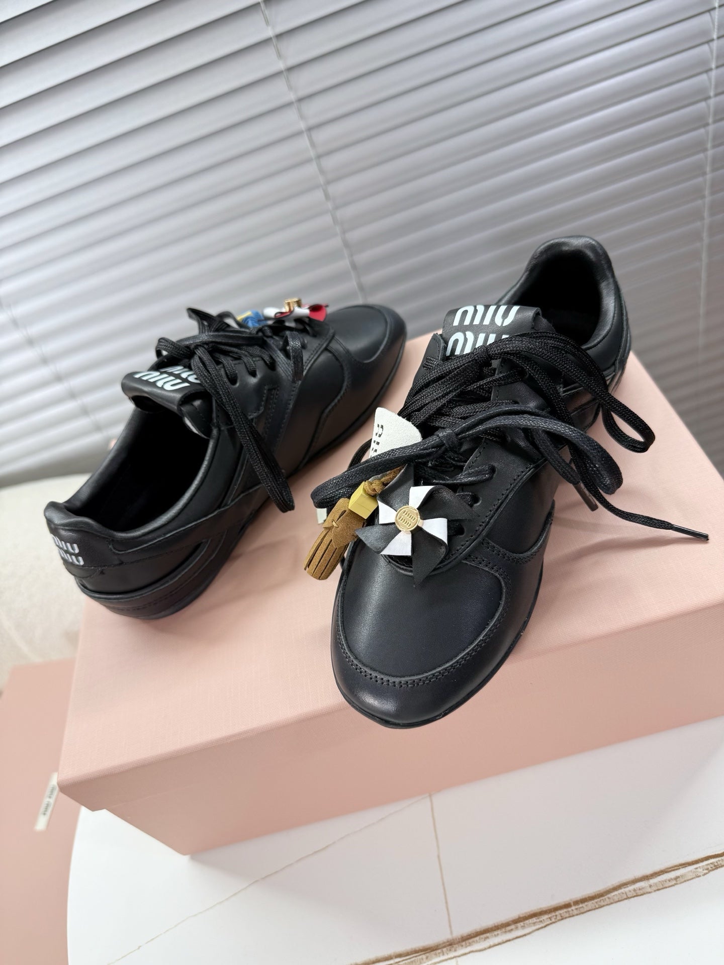 MIUMIU 26S GYMNASIUM SNEAKER IN BLACK CALFSKIN WITH GOLD BUCKLED STRAP