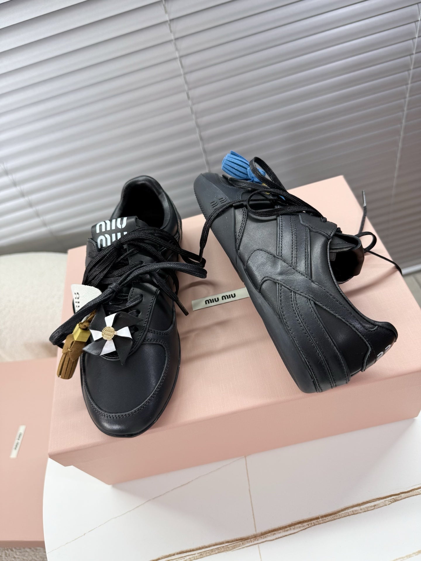 MIUMIU 26S GYMNASIUM SNEAKER IN BLACK CALFSKIN WITH GOLD BUCKLED STRAP