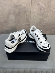 CHANEL 26S RUNNER CC LOGO SNEAKERS IN WHITE AND BLACK CALFSKIN