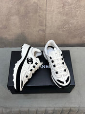 CHANEL 26S RUNNER CC LOGO SNEAKERS IN WHITE AND BLACK CALFSKIN