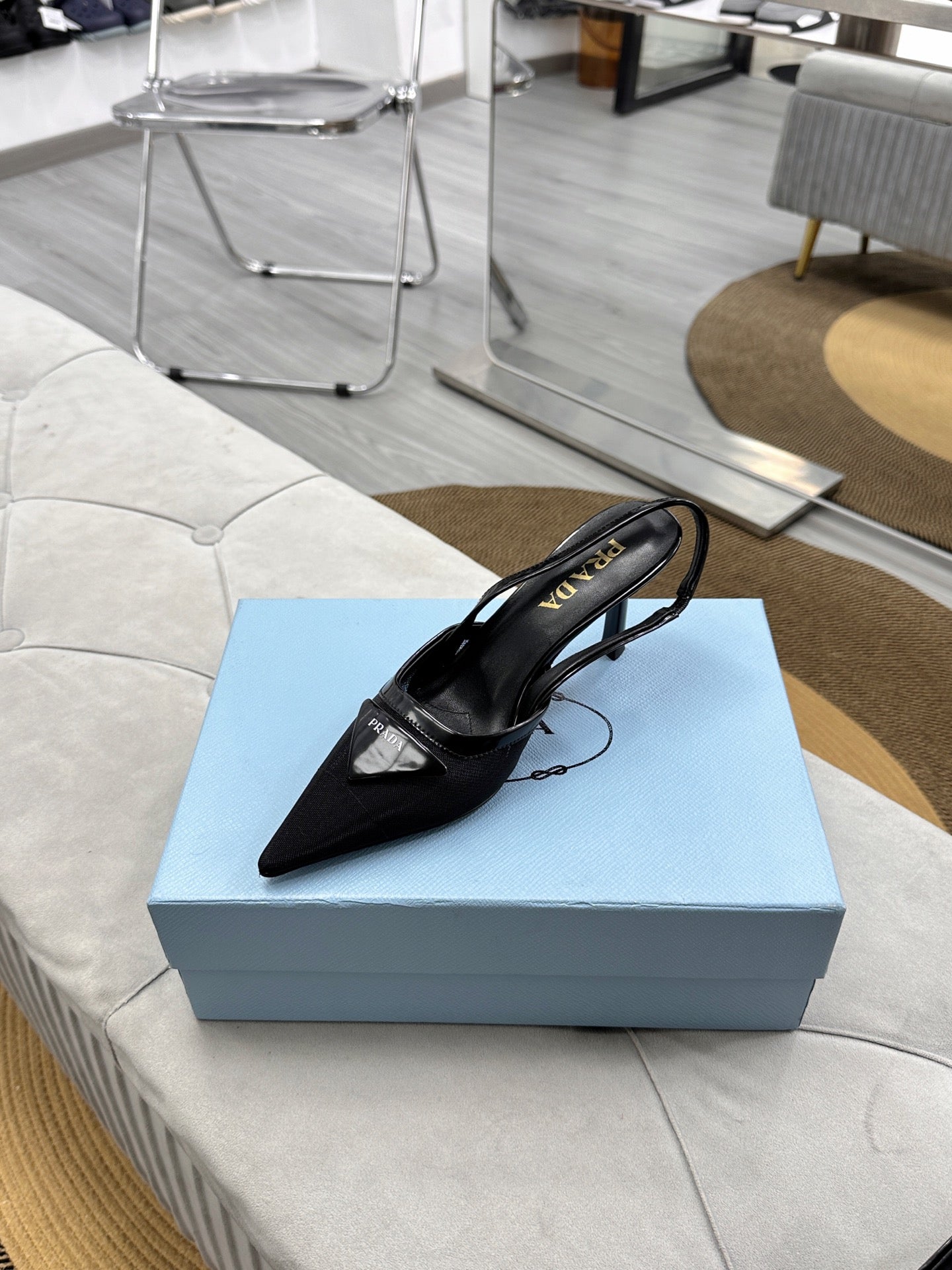 PRADA 25S TRIANGLE LOGO SLINGBACK PUMPS IN BLACK MESH FABRIC