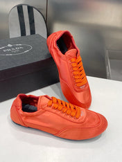 PRADA 26S SNEAKERS IN BURNT ORANGE SATIN