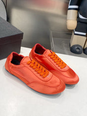 PRADA 26S SNEAKERS IN BURNT ORANGE SATIN