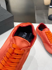 PRADA 26S SNEAKERS IN BURNT ORANGE SATIN