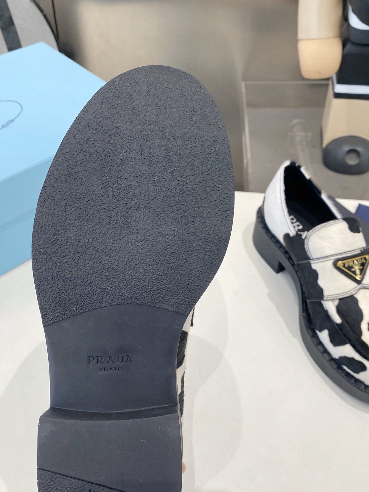 PRADA 26S LOAFERS IN WHITE AND BLACK COW PRINT PONY HAIR