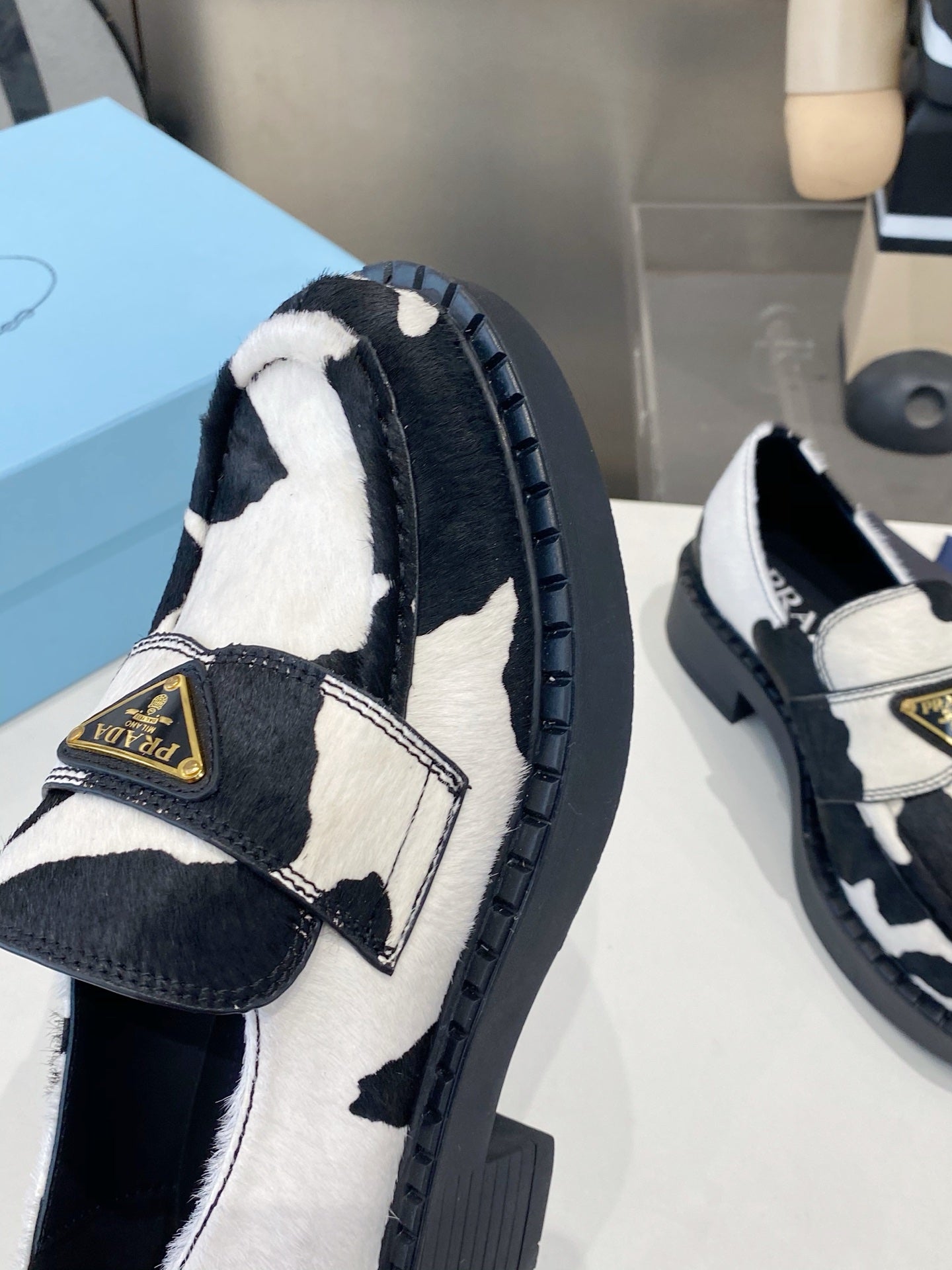 PRADA 26S LOAFERS IN WHITE AND BLACK COW PRINT PONY HAIR