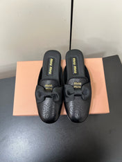 BOW MULES IN BLACK SHEEPSKIN