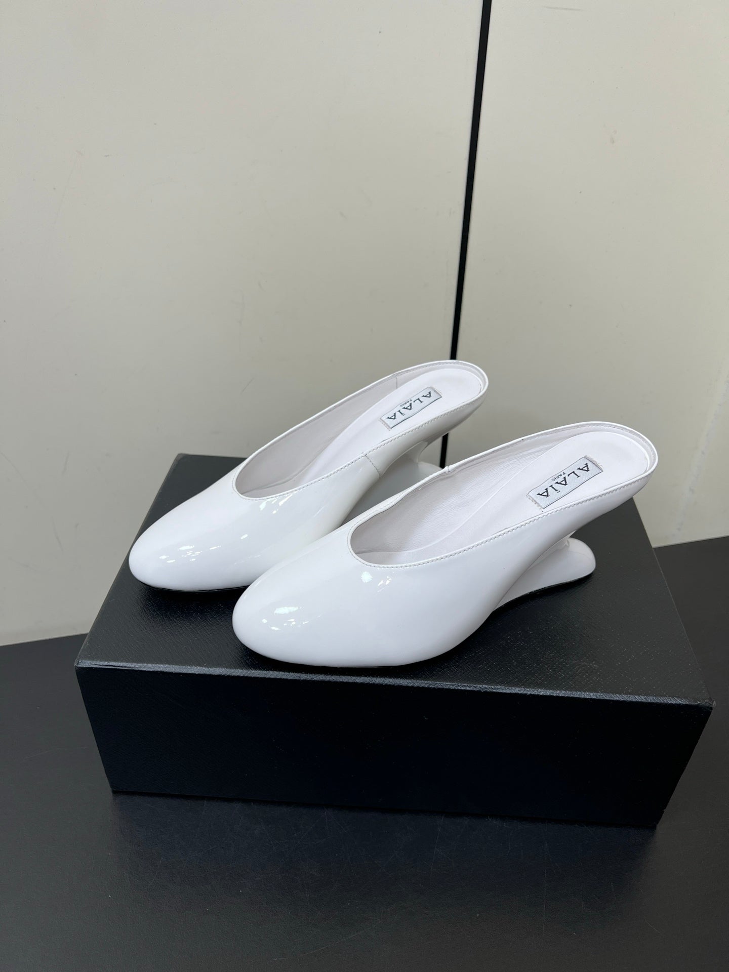 ALAIA WEDGE MULES 25S IN CREAM WHITE LAMBSKIN