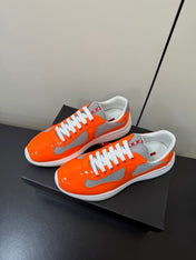 PRADA 26S SNEAKERS IN ORANGE PATENT CALFSKIN AND WHITE MESH