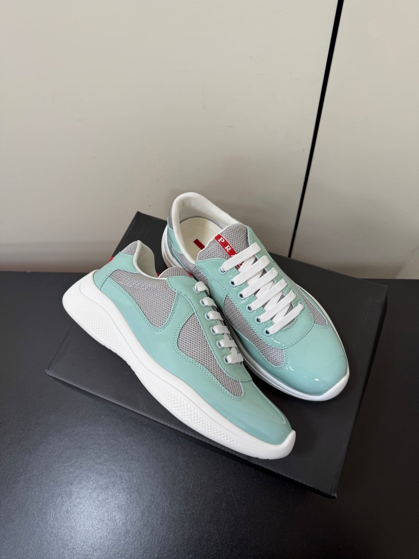 PRADA 26S SNEAKERS IN SOFT TEAL PATENT CALFSKIN AND WHITE MESH