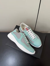 PRADA 26S SNEAKERS IN SOFT TEAL PATENT CALFSKIN AND WHITE MESH