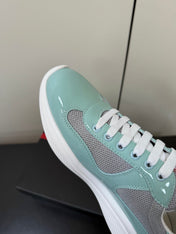 PRADA 26S SNEAKERS IN SOFT TEAL PATENT CALFSKIN AND WHITE MESH