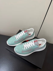 PRADA 26S SNEAKERS IN SOFT TEAL PATENT CALFSKIN AND WHITE MESH