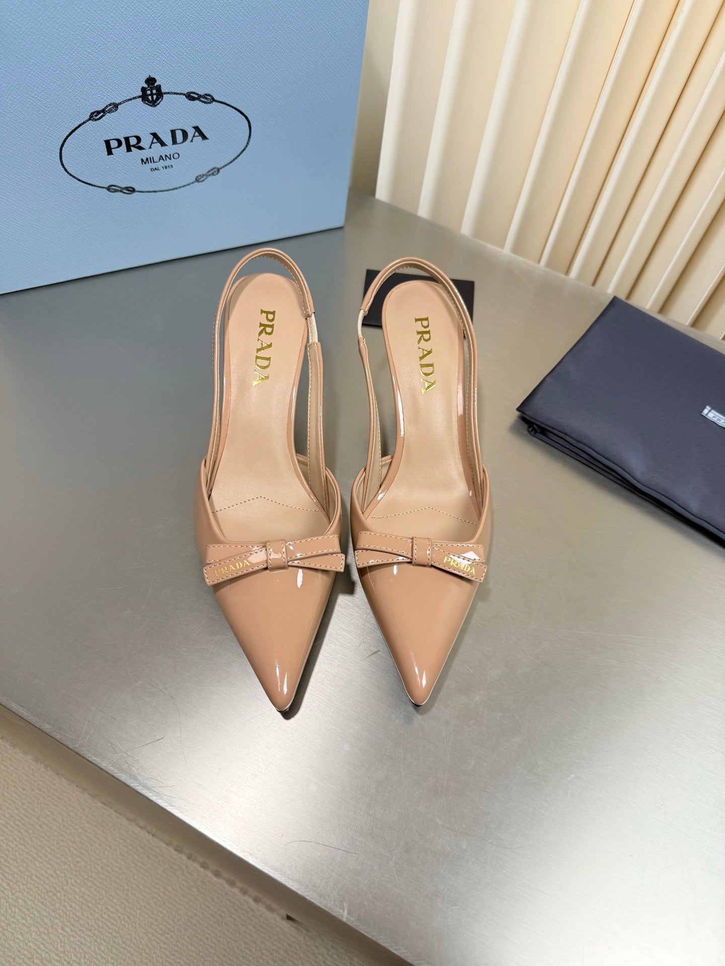 PRADA 26S POINTED-TOE SLINGBACK PUMPS IN BEIGE PATENT CALFSKIN WITH BOW