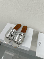 ALAIA VIENNE FLAT MULES IN SILVER LAMBSKIN