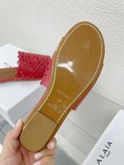 ALAIA VIENNE FLAT MULES IN CHERRY RED LAMBSKIN