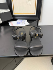 FLAT SANDALS IN BLACK CALFSKIN WITH BOW