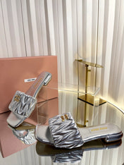 MIUMIU 26S MATELASSE SLIDES IN SILVER CALFSKIN GOLD HARDWARE