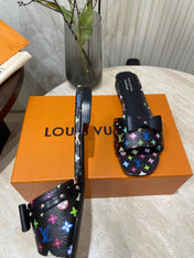 BOW FLAT MULES IN BLACK MONOGRAM LAMBSKIN