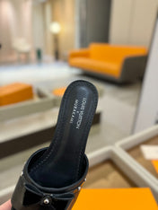 LV X TM 6AM FLAT MULE IN BLACK CALFSKIN