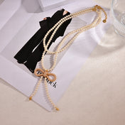 CD 26S PEARL BOW DROP STATEMENT NECKLACE IN GOLD TONE METAL 629848