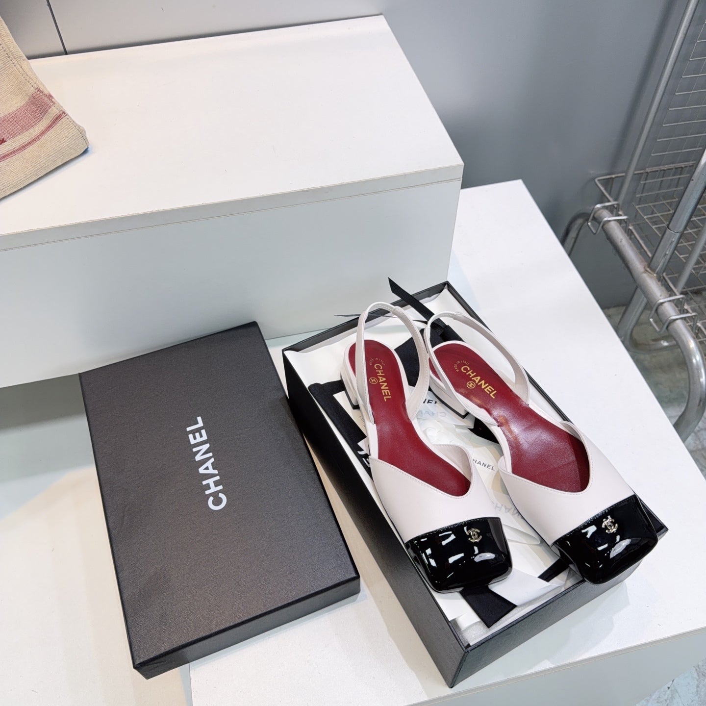 CHANEL 26S FLAT SLINGBACK IN WHITE LAMBSKIN WITH BLACK CAP TOE