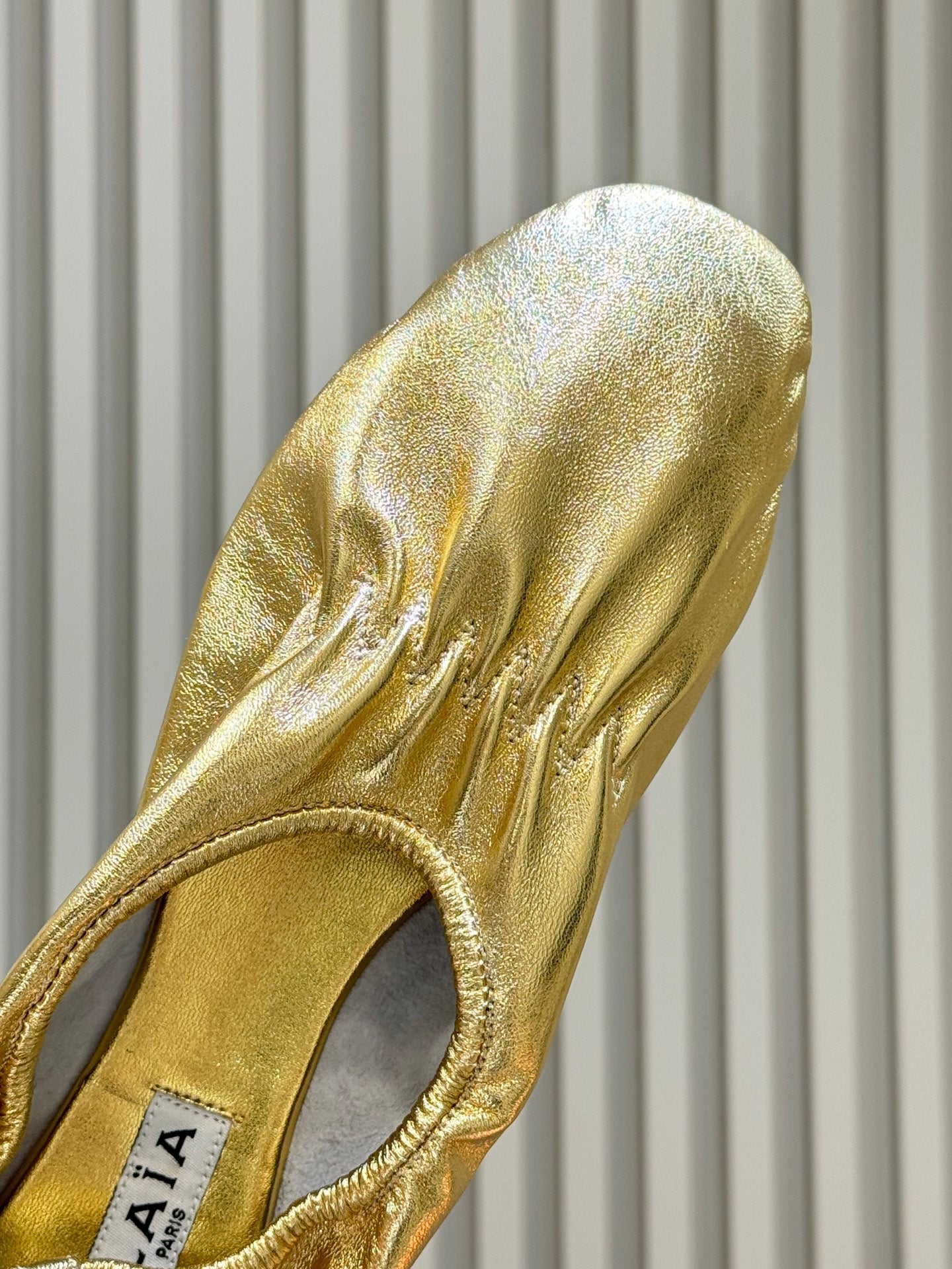 ALAIA 26S BALLET FLATS IN GOLD LAMBSKIN