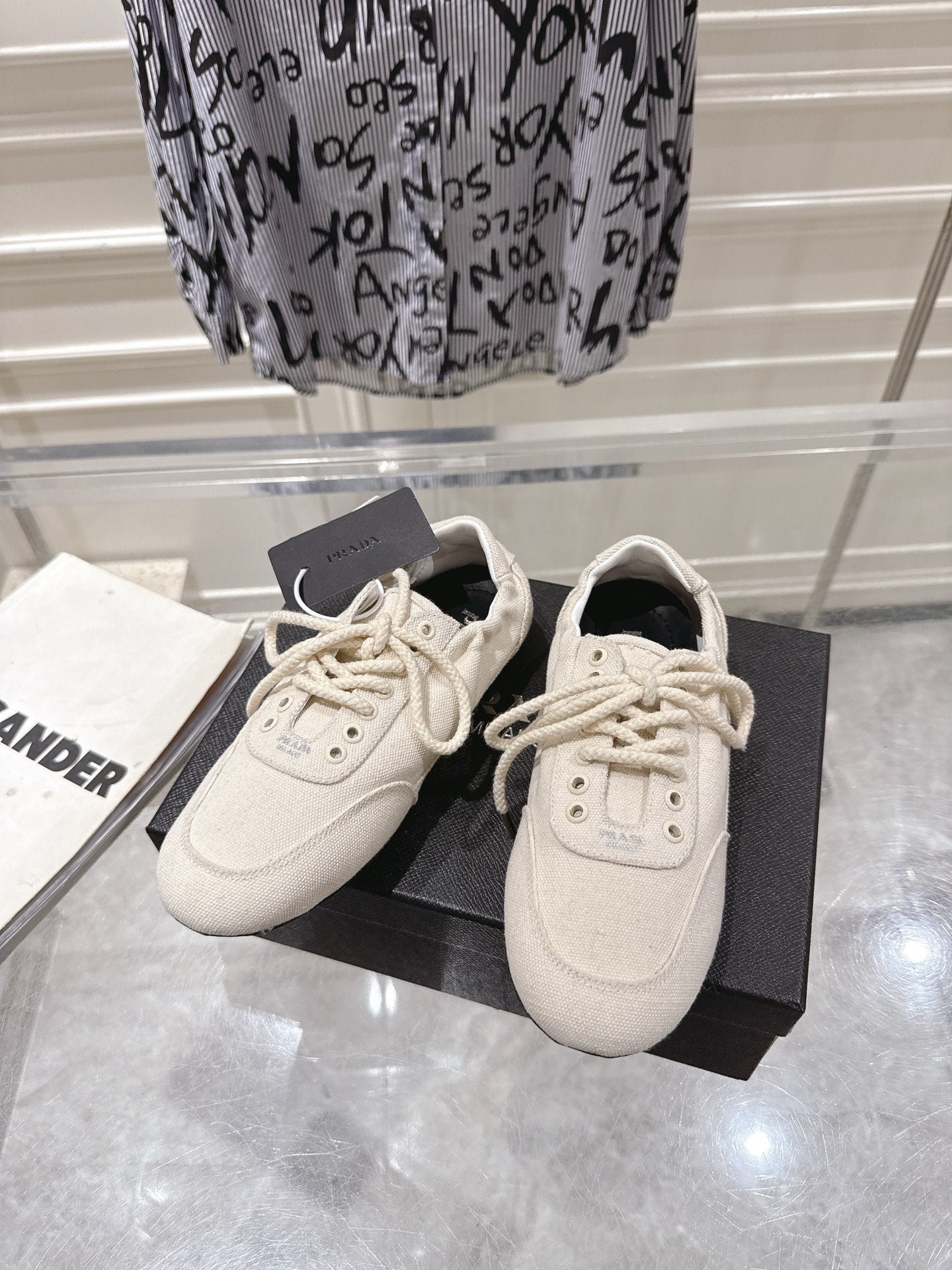 PRADA 26S COLLAPSE SNEAKERS IN WHITE CANVAS