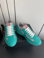 PRADA 26S AMERICA CUP SNEAKERS IN TEAL BLUE SOFT RUBBER AND BIKE FABRIC