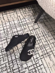 FLAT MULES IN BLACK CALFSKIN