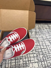 PRADA 26S LACE UP SNEAKERS IN RED CANVAS